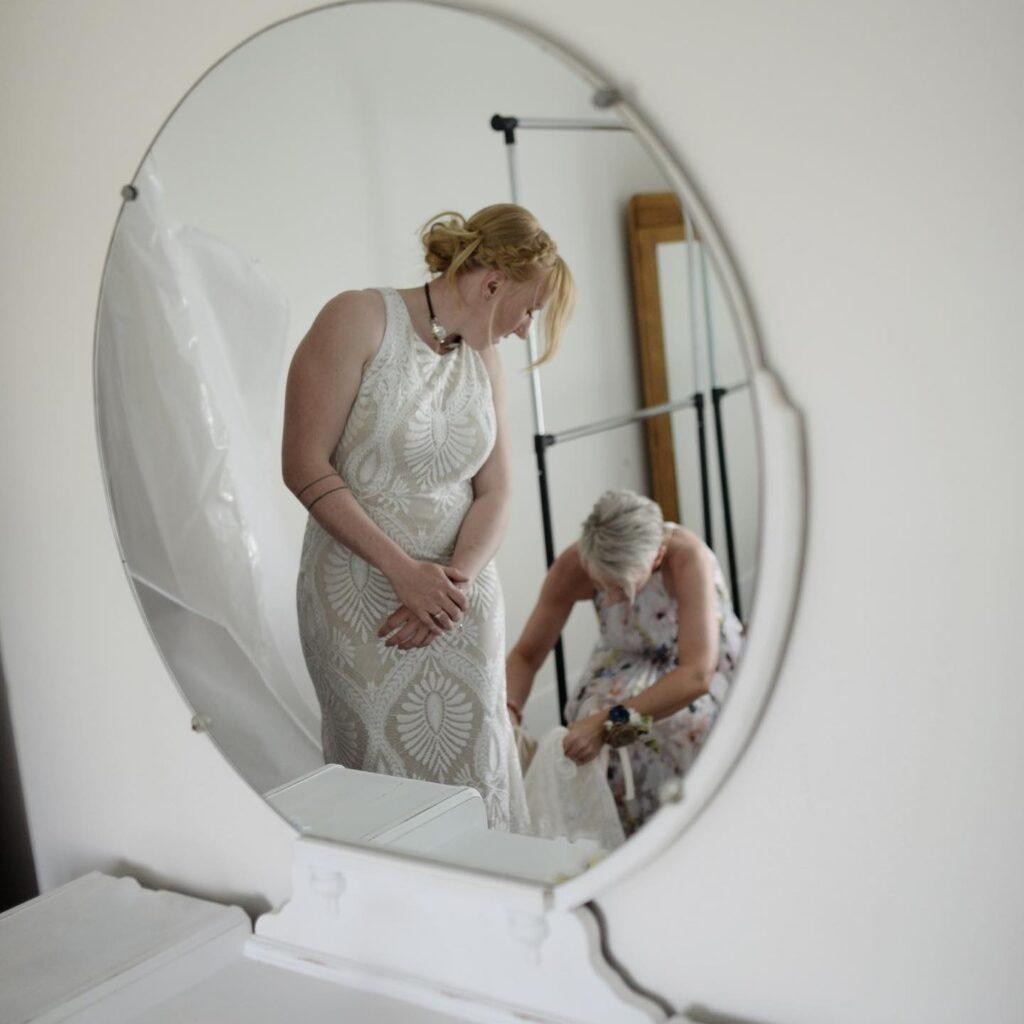 Bride gets final touches from her Mom in the Bridal Suite