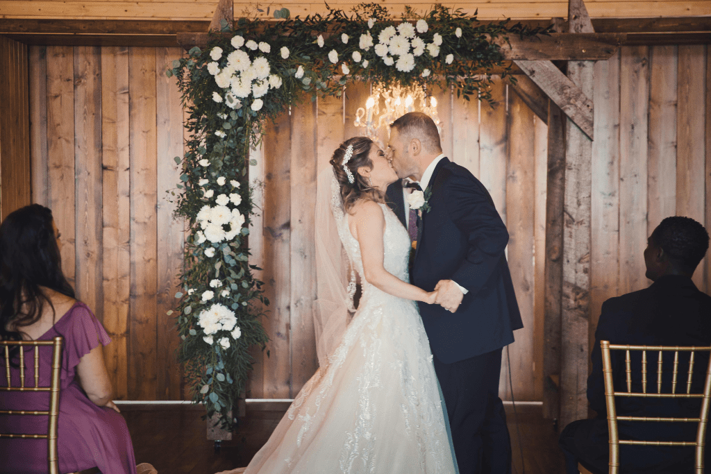 Say I Do under the Custom Wooden Wedding Arch in the Heritage Barn indoor Ceremony Space 