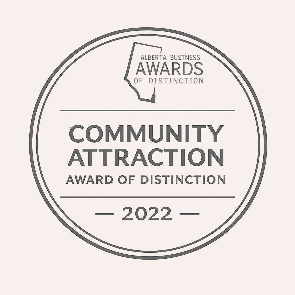 Circular award badge reading 'Community Attraction Award of Distinction 2022' with the Alberta Business Awards of Distinction logo at the top.