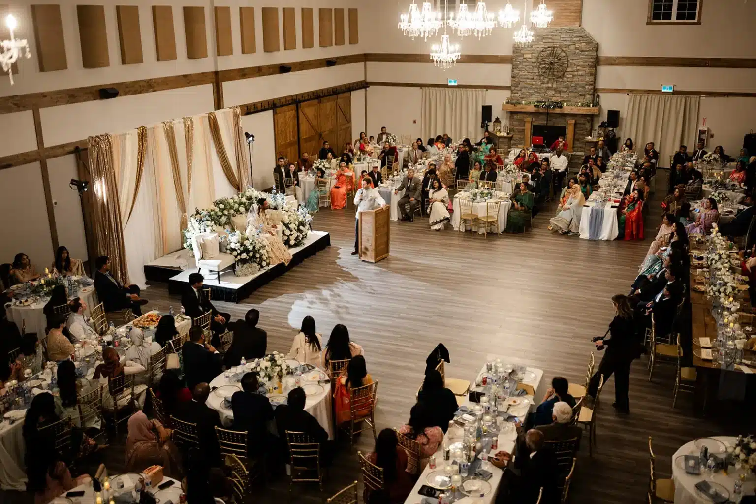 South Asian wedding reception with floral stage in the Grand Ballroom at The Heritage Centre.
