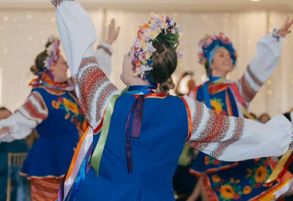 Ukrainian dancers performing in traditional attire during a Grand Ballroom wedding.